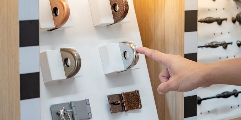 Designer,Hand,Pointing,At,Fixed,Metal,Latch,Padlock,Staple,On
