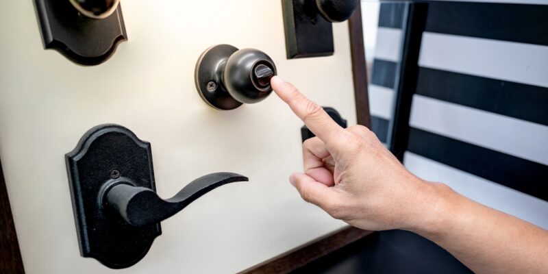 Designer,Hand,Pointing,At,Vintage,Door,Knob,With,Lock,On