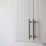 White,Kitchen,Cabinets,With,Metal,Pulls,Or,Knobs,On,The