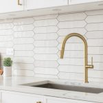 A,Beautiful,Kitchen,Faucet,Detail,With,White,Cabinets,,A,Gold
