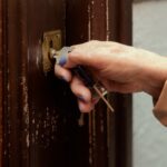 Older,Woman's,Hands,Locking,The,Door,To,Her,Home