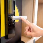 Customer,Hand,Pointing,At,Door,Handle,Of,Smart,Digital,Door