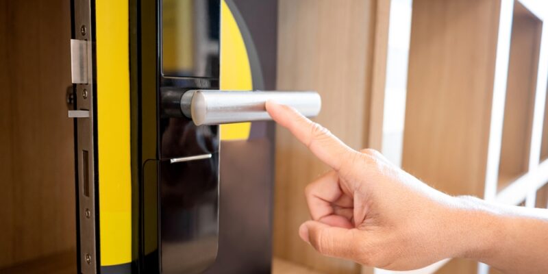 Customer,Hand,Pointing,At,Door,Handle,Of,Smart,Digital,Door